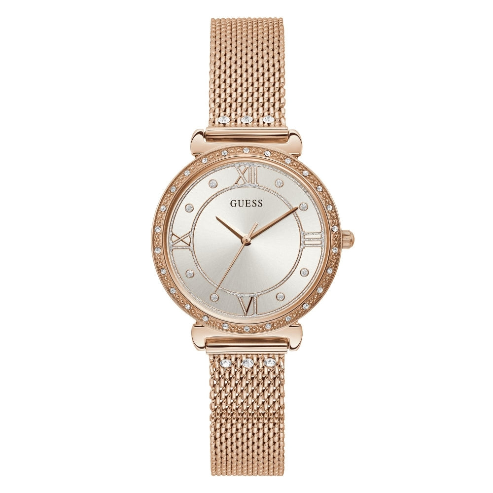 GUESS W1289L3 Ladies Jewel Watch in rose gold tone features a mesh bracelet, round face with Roman numerals, and a crystal-studded bezel.