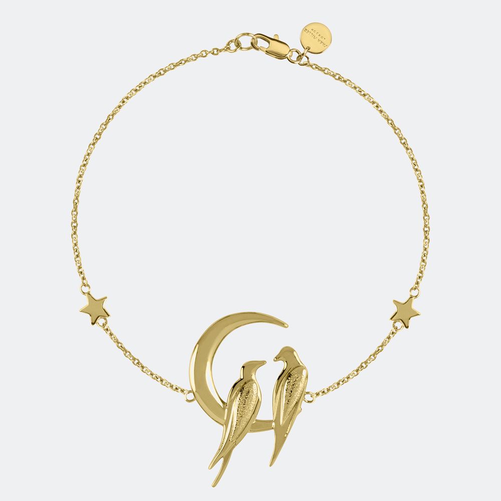 The Sara Miller Moon Light Bracelet SAJ3000 features two lovebirds on a crescent moon with star charms, crafted in 18ct gold plate and set on a delicate chain with clasp from our Moonlight Collection.