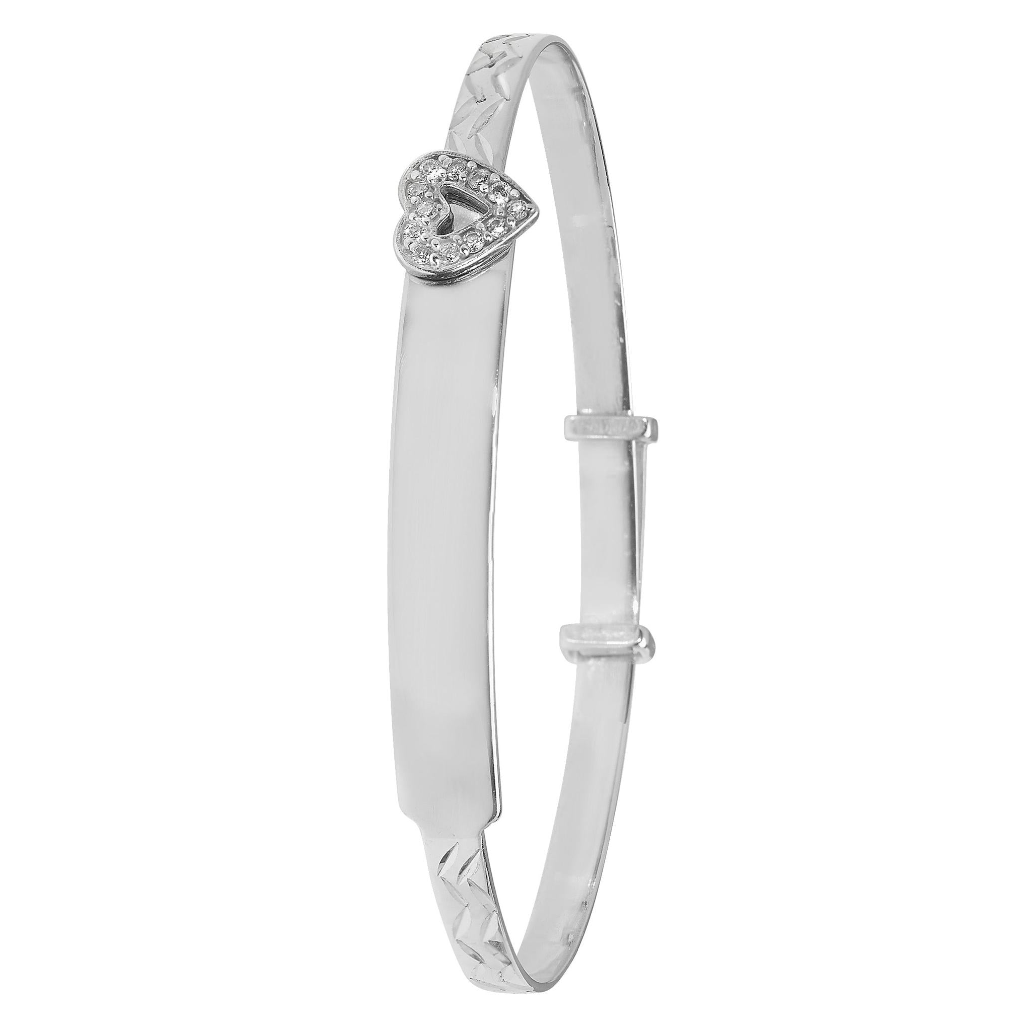The STERLING SILVER BABY ID PLATE/HEART BANGLE features a heart-shaped charm with sparkling stones, an adjustable band, and a plain central plate—ideal as a babies' ID bracelet for your little one.