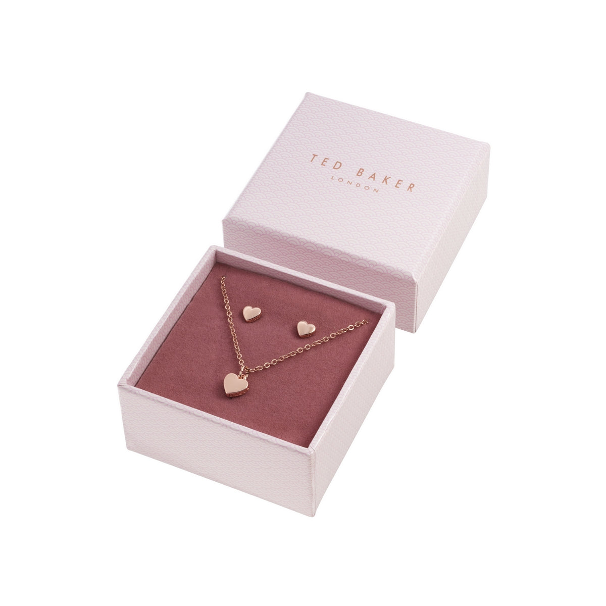 The TED BAKER Amoria Gift Set (TBJ1222-24-03) features a rose gold heart pendant necklace (Hara) and matching heart stud earrings (Harly), beautifully presented in an open jewelry box with a soft pink and mauve interior.