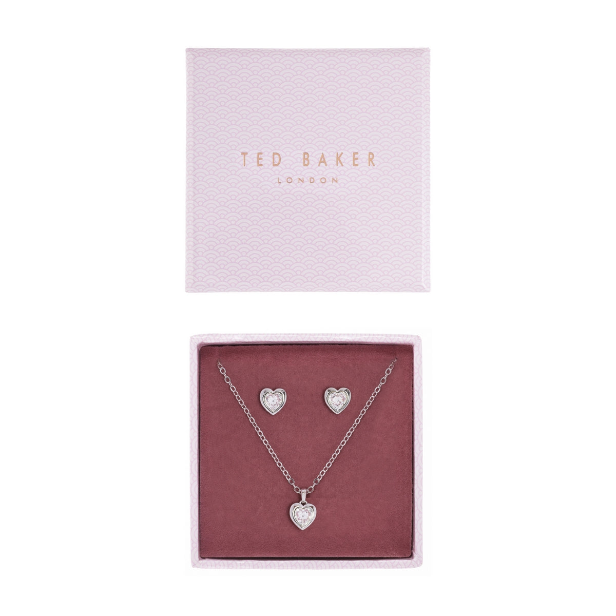 The TED BAKER Hadeya Swarovski Crystal Heart Pendant Necklace and Earring Gift Set TBJ1943-01-02 includes a silver heart pendant necklace and matching earrings with sparkling crystals, beautifully presented in a pink gift box.