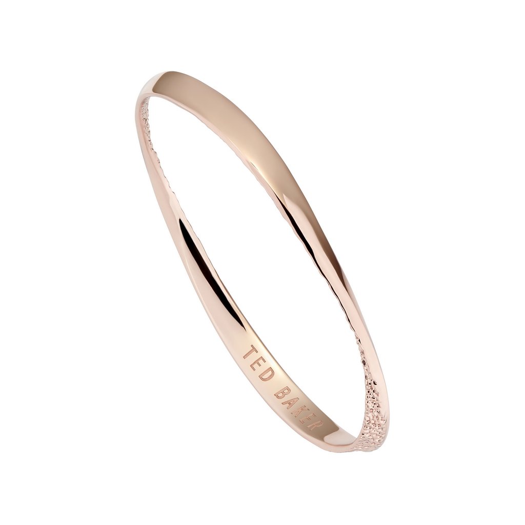 The Ted Baker Helmara Rose Gold-Tone Hammered Hoop Textured Bangle TBJ2696-24-03 features a hammered hoop design, "TED BAKER" engraved inside, and a textured accent on one end.