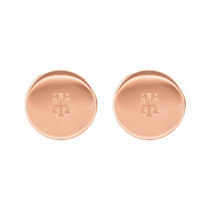 TOMMY HILFIGER Ladies Rose Gold Tone Stainless Steel Stud Earrings 2780272 feature a round design with an engraved overlapping "TH" monogram at the center.