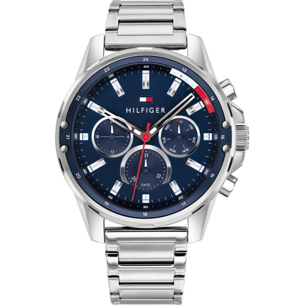 The Tommy Hilfiger Manson 1791788 is a men’s watch with a blue dial, three subdials, date window, and a silver-tone stainless steel bracelet.