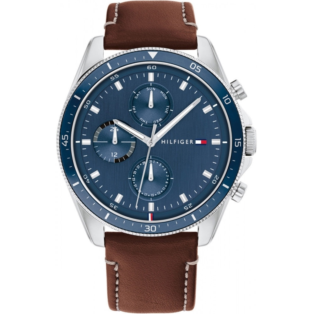 The Tommy Hilfiger 1791837 Men's Parker Watch has a blue dial with three subdials, a stainless steel case, brown leather strap, and signature Hilfiger logo for a stylish look.