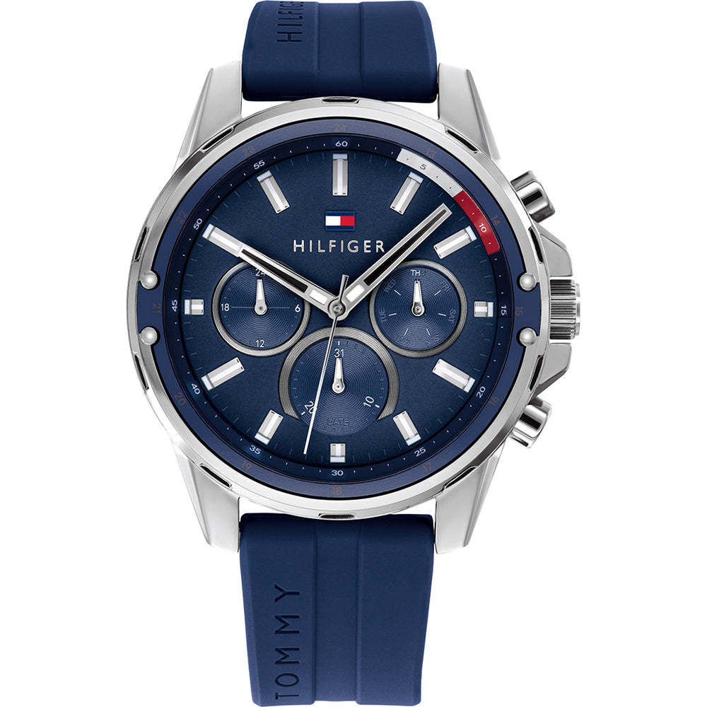 The Tommy Hilfiger 1791791 Mason Men's Watch features a chronograph round dial with silver markers, three subdials, and a blue silicone strap. Water-resistant, this stylish blue watch is perfect for everyday wear.