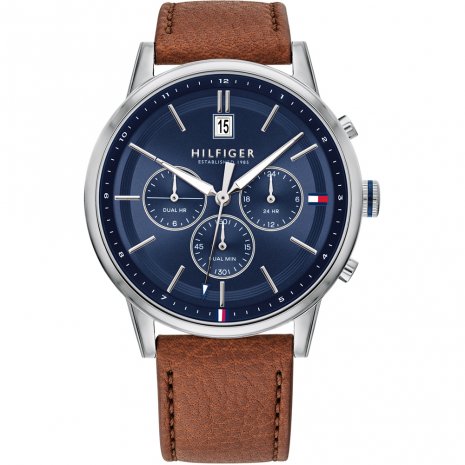The Tommy Hilfiger 1791629 Kyle features a blue dial, brown leather strap, three subdials, a date window at 12 o'clock, and silver hour markers.